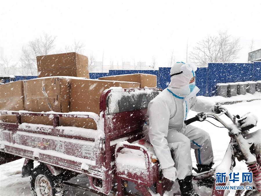 Voluntários universitários entregam suprimentos no vento forte e na neve